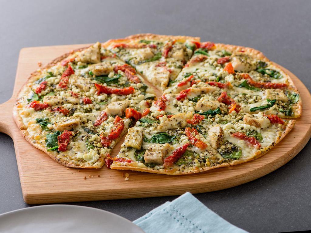 Herb Chicken Mediterranean Pizza (Baking Required) · Chicken, Spinach, Sun-dried Tomatoes, Feta, Zesty Herbs, Olive Oil and Garlic, Artisan Thin Crust