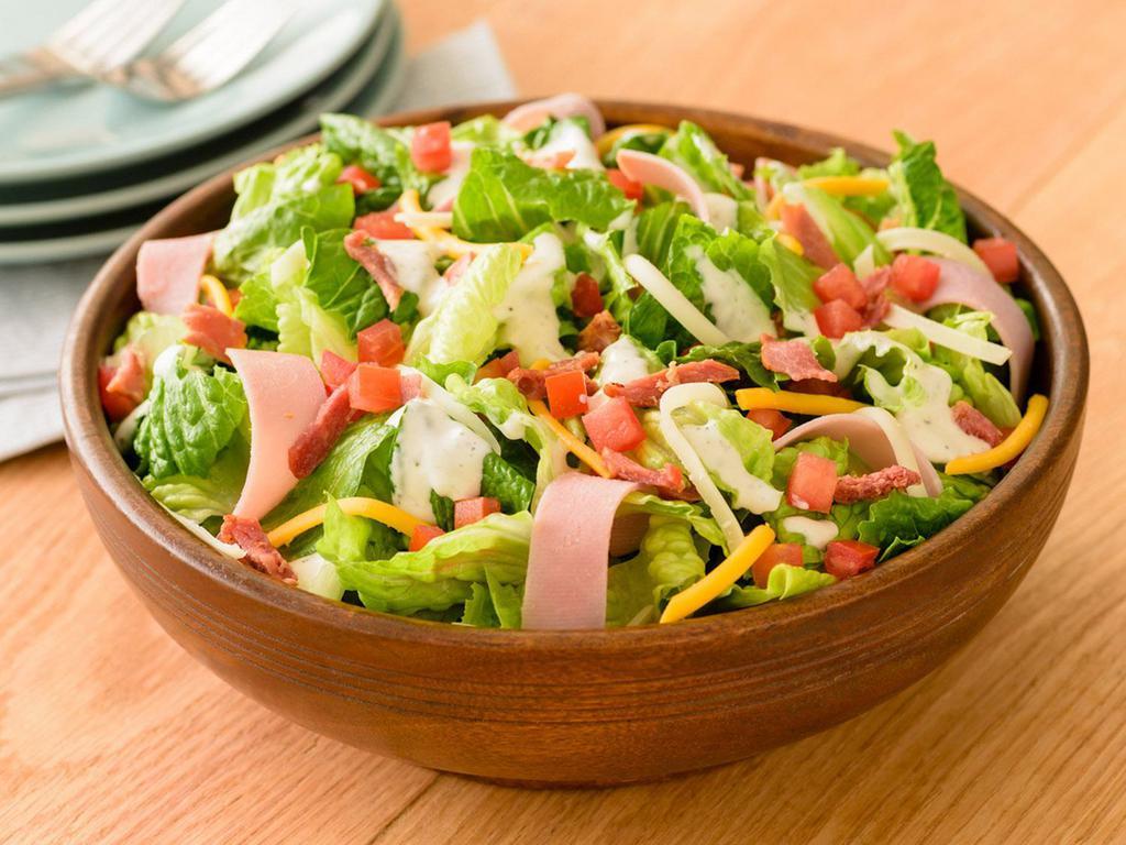 Club Salad · Romaine, bacon, Canadian bacon, Roma tomatoes, a blend of mozzarella and cheddar cheeses and ranch dressing.