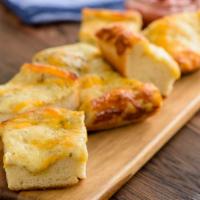 Scratch-Made 5 Cheese Bread (Baking Required) · Fresh Dough with Herb Garlic Spread and 1/4 pound of Mozzarella and Cheddar cheese, side of ...
