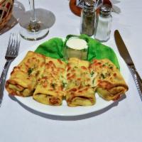 Blini Meat & Cheese · 4 blintzes filled with beef baked in the oven and topped mozzarella cheese.