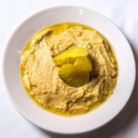 Hummus · Chickpeas, tahini, fresh garlic with olive oil and lemon juice. Served with pita bread.