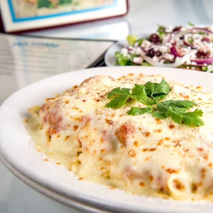 Chicken Parmigiana Spaghetti · Breaded chicken topped with tomato sauce and melted mozzarella cheese and Parmesan cheese. Served with pitra bread and greek salad