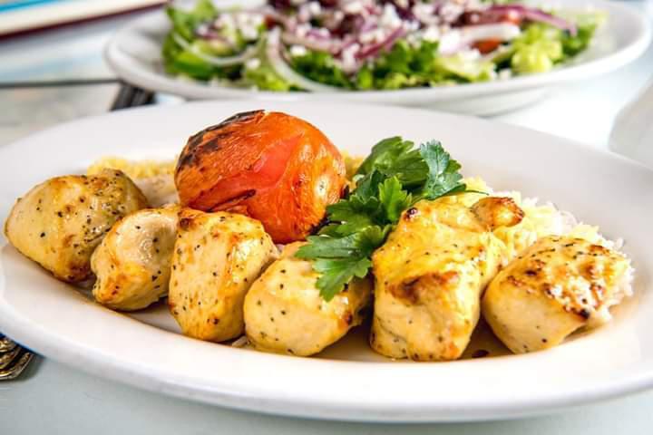 Chicken kabob · A skewer of boneless chicken breast chunks marinated in saffron sauce and char-broiled. Served with basmati rice, pita bread and salad.