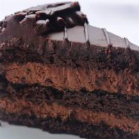 Chocolate Mousse Cake · Decadent chocolate cake layered with chocolate mousse and topped with chocolate icing and ch...