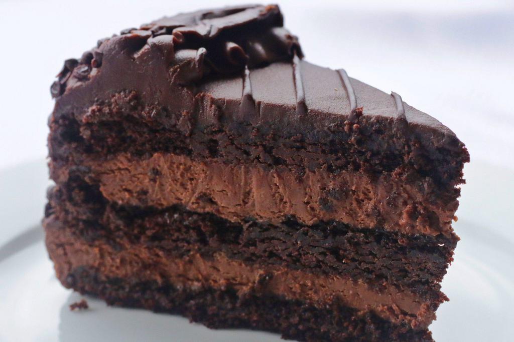 Chocolate Mousse Cake · Decadent chocolate cake layered with chocolate mousse and topped with chocolate icing and chocolate chips..... chocolately