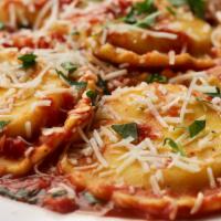 Cheese Ravioli · Jumbo ravioli noodles stuffed with ricotta cheese, simmered in tomato sauce, and topped with...