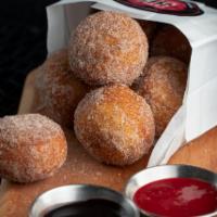Bag O' Donuts · House made donut balls rolled in cinnamon sugar and served with raspberry, chocolate & caram...