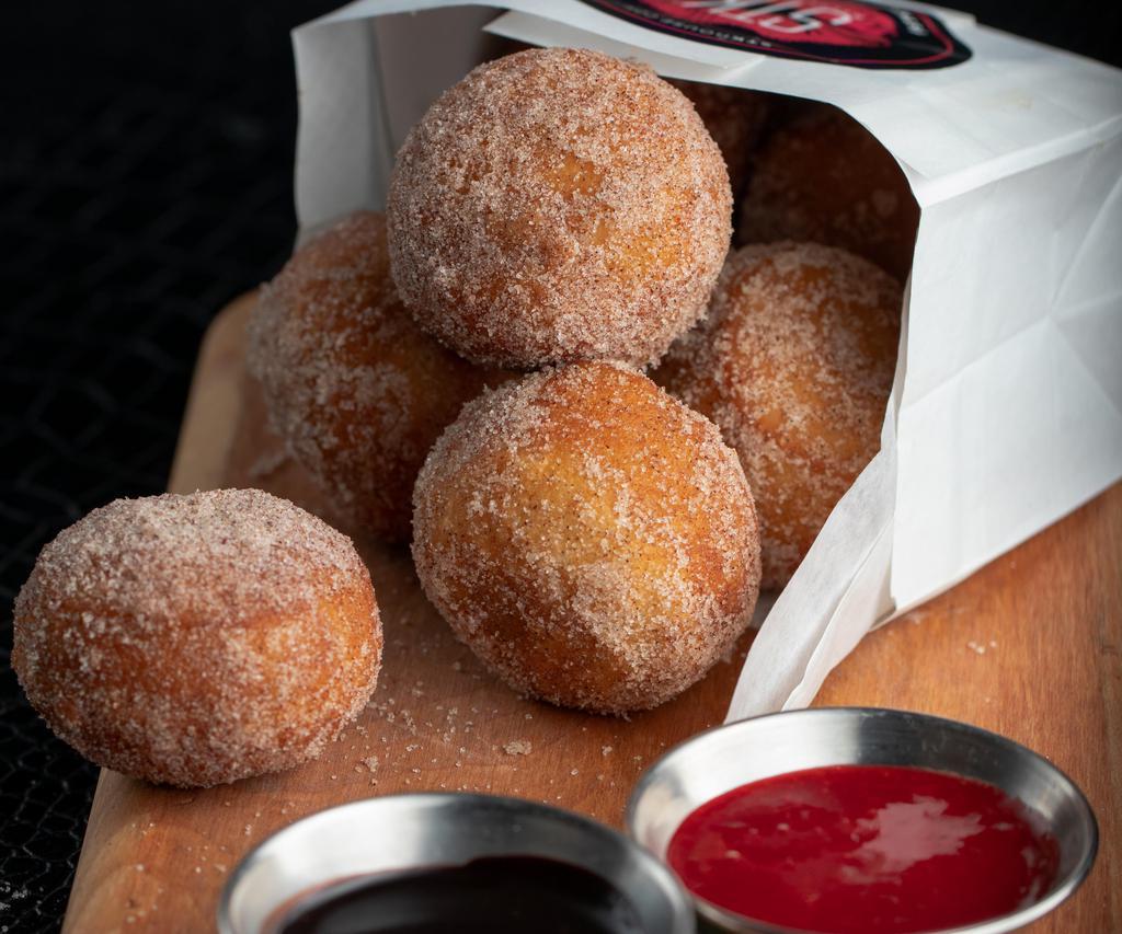 Bag O' Donuts · House made donut balls rolled in cinnamon sugar and served with raspberry, chocolate & caramel sauces.