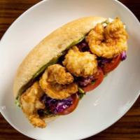 Crispy Shrimp Po’ Boy · Southern fried shrimp sandwich topped with avocado, lettuce, spicy remoulade sauce & tomatoe...