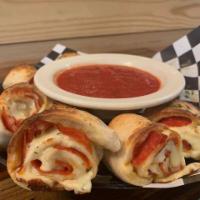 Roni Rolls · Pizza dough rolled up with pepperoni and mozzarella and baked, served with marinara.