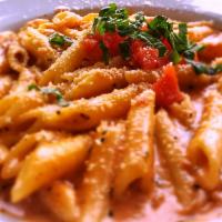 Penne Ala Vodka · Rich, creamy tomato sauce, lots of Parmesan, 
garlic, and a touch of vodka, topped with fres...