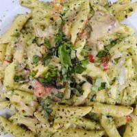 Artichoke Pesto Pasta · Fresh creamy basil pesto and penne pasta tossed with artichoke hearts, sautéed tomatoes, and...