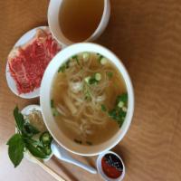 P2. Pho Tai (New York Steak) · 5 oz. of New York steak strip in a rich beef broth with fresh rice noodles.