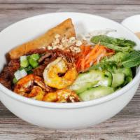 B2. Bun Thit Nuong Hoac Ga Nuong, Cha Gio & Shrimp · Contains gluten. Grilled pork or chicken, egg roll and shrimp with rice noodles on a bed of ...
