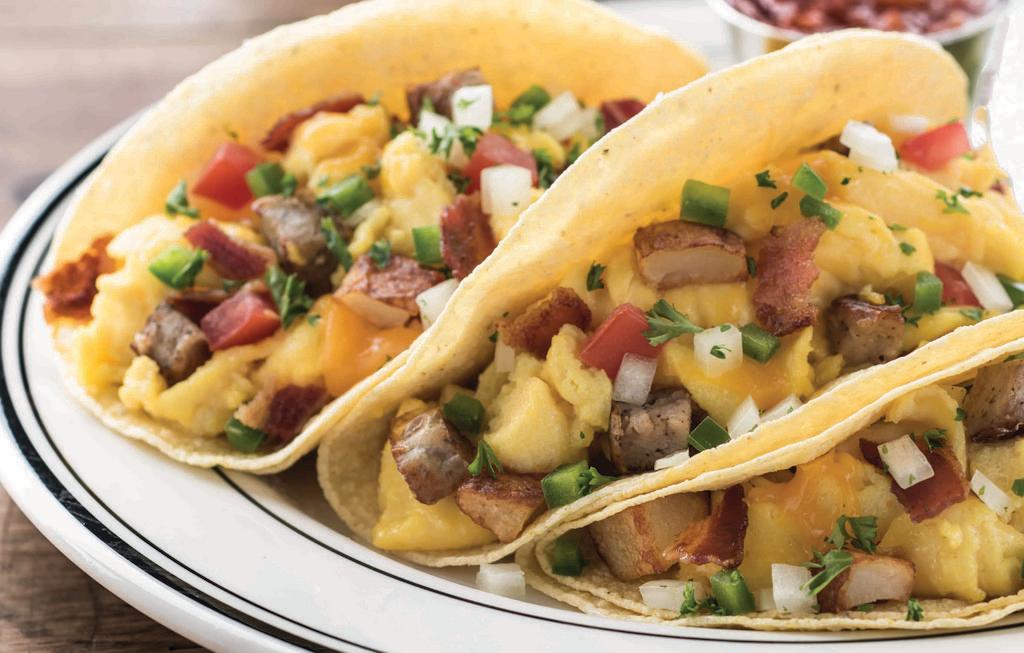 Farmhouse Breakfast Tacos · Hickory-smoked bacon, sausage, scrambled eggs, roasted potatoes, cheddar cheese, jalapeño, tomato, onion and cilantro in flour tortillas. Served with salsa. Add avocado for an additional charge.