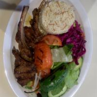 64. Lamb Chops · 3 pieces of grilled seasoned baby lamb chops served over rice and green salad