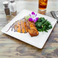 Salmon Specialty · Pan-roasted, with pistachio butter, rice, spinach, and garlic olive oil.