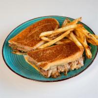 Cubano Sandwich · Cuban sandwich with roasted pork, ham, Swiss, pickle, mustard, toasted and topped off with o...