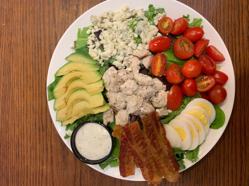 Kamuela Cobb Salad · Grape tomatoes hard boiled egg bacon avocado bleu cheese mixed field greens herb ranch dressing and grilled chicken breast.