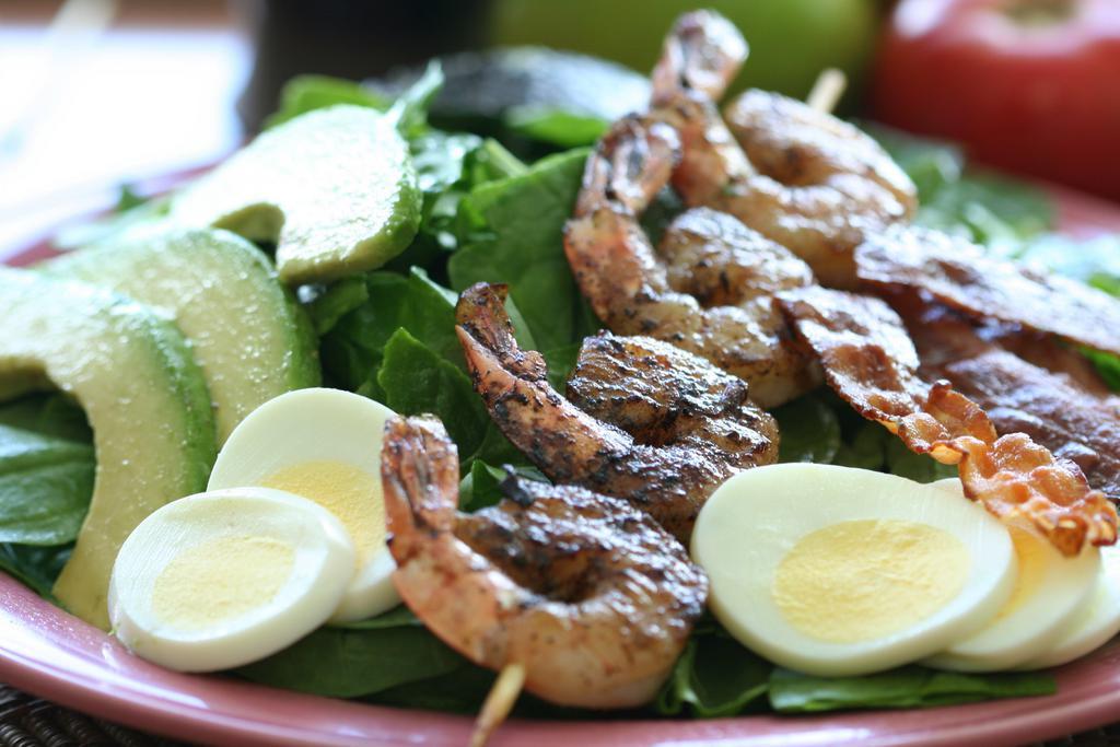 Kahuku Spinach Salad · Hard boiled egg, avocado, bacon, baby spinach, papaya seed dressing and grilled shrimp.
