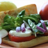 Caprese Sandwich · Hau'ula tomatoes, red onions, basil, fresh mozzarella, mixed field greens and balsamic vinai...