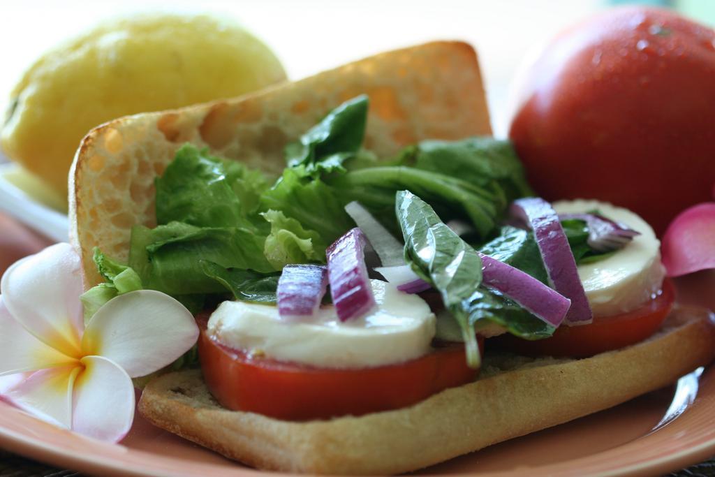 Caprese Sandwich · Hau'ula tomatoes, red onions, basil, fresh mozzarella, mixed field greens and balsamic vinaigrette.