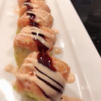 Snow Mountain Roll · Shrimp, mango, avocado and crunch wrapped with soy paper. Topped with spicy crab. Prepared w...