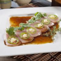 Garlic Hamachi Sashimi · Yellowtail topped with spicy yuzu ponzu sauce, garlic paste, jalapeno and cilantro.