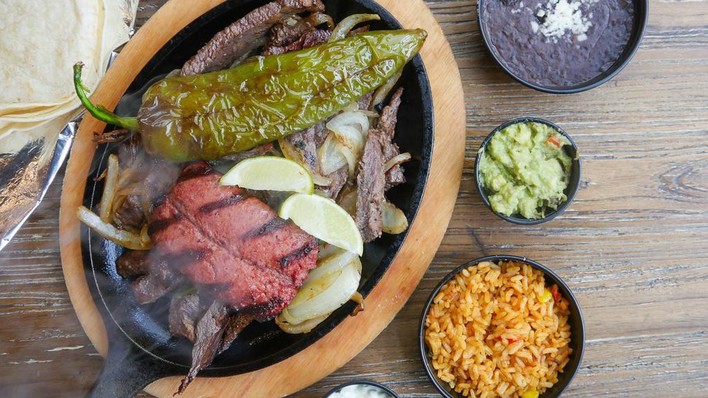 #24. Carne Asada · Grilled sirloin served with grilled onions, jalapenos, salad, avocado, rice, beans and tortillas.