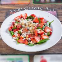 Strawberry Spinach Salad · Fresh spinach topped with fresh strawberries, bleu cheese crumbles and walnuts topped with s...
