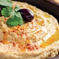Hummus · Cooked mashed chickpeas blended with tahini sauce, garlic, lemon juice and olive oil. comes ...