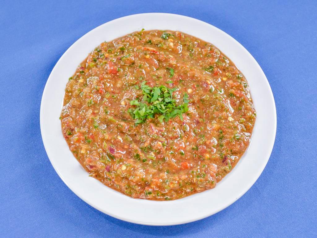 Spicy Turkish Salad Dip · Finely chopped tomatoes, parsley, jalapeno, onions, pomegranate molasses, herbs and spices. Served with seasoned pita chips.