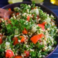 Tabbouleh · Fresh herb salad with chopped parsley bulgur, tomatoes, cucumber, fresh mint, and onions dre...