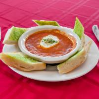 Queso de Cabra · Oven-baked goat cheese in tomato basil sauce, served with garlic bread.