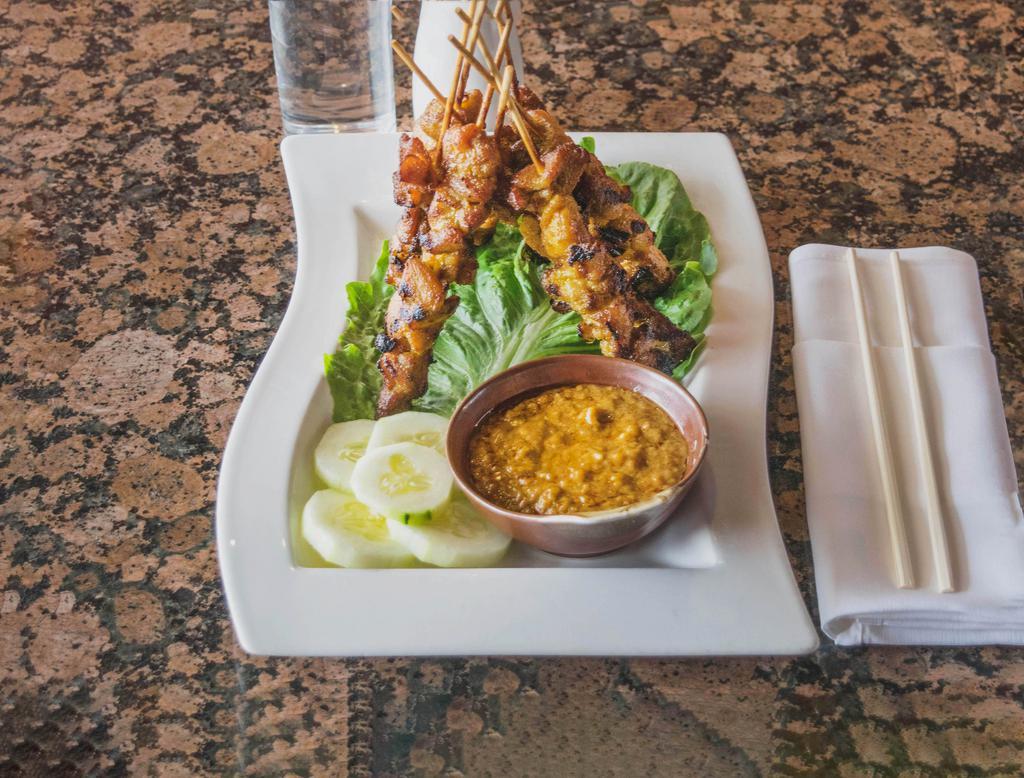 4 Pieces Chicken Satay · Marinated chicken on a skewer with peanut sauce.