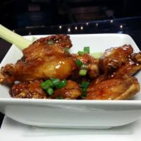 Wings · Red chili sauce, hot sauce, BBQ with sesame.