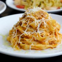 Fettuccine Bolognesi · Fresh homemade fettuccine pasta, classic Italian Bolognese sauce, Parmigiano.
