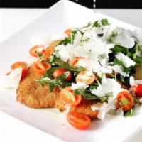 Chicken Milanese · Lightly breaded chicken breast, arugula and cherry tomatoes salad with Italian balsamic dres...
