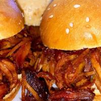 Pulled Pork Sandwich · Our house smoked BBQ pulled pork with melted American cheese, red onion, and pickles on a to...