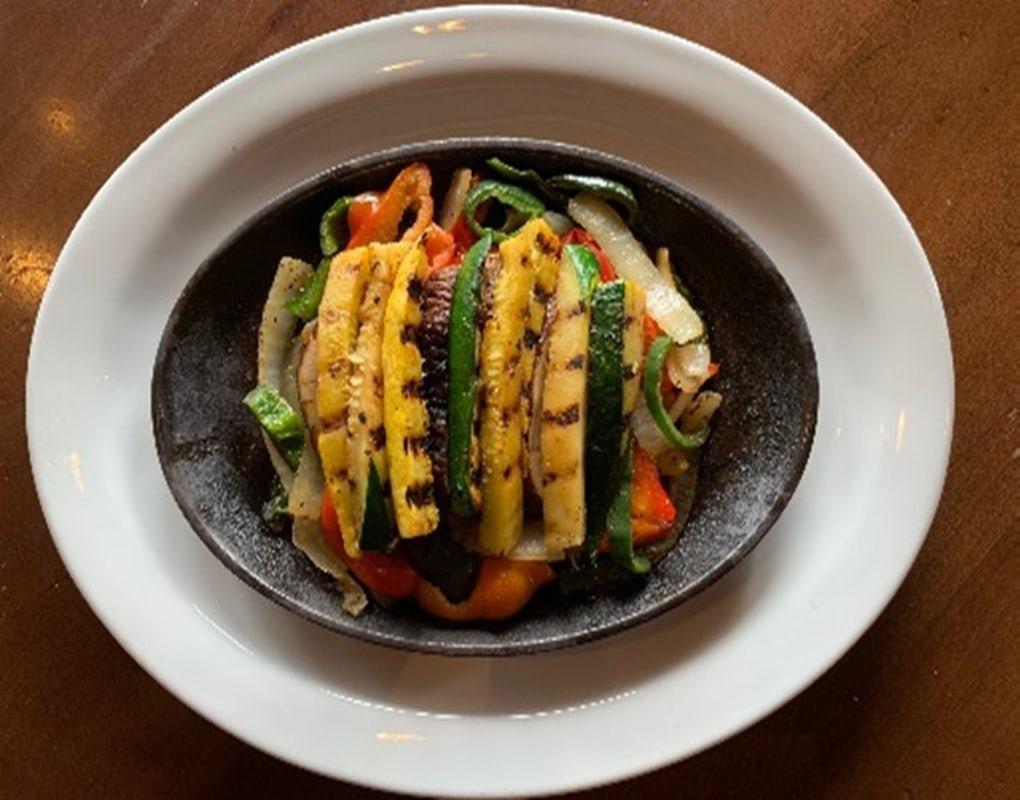 Grilled Vegetable Fajitas for Two · Mesquite grilled vegetables including zucchini, yellow squash, portobello mushrooms, sautéed peppers, and onions. Served with fresh guacamole, sour cream, cheese, pico de gallo, with our homemade flour tortillas and black beans.