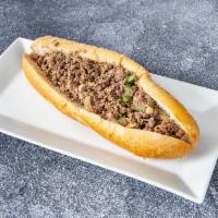 Steak Bomb Sub · Made with Shaved Ribeye, onions, peppers, Genoa salami and cheese.