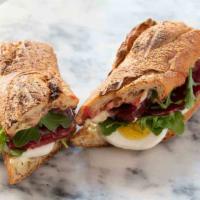 #2 - Boiled Egg and Beet · Medium boiled egg, house pickled beet, red onion and remoulade on a baguette.  Our eggs are ...