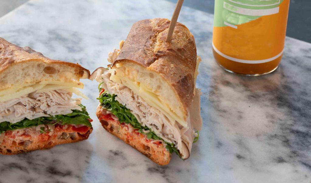 #4 - Turkey · With peppadews, house pickled shallots, manchego, arugula and harissa mayo on a toasted baguette