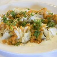 MANTU · Ground beef, onion and Afghani spices
stuffed dumpling.
topped with Afghani sauce