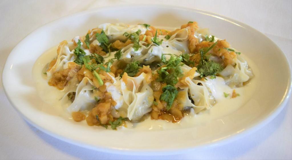 MANTU · Ground beef, onion and Afghani spices
stuffed dumpling.
topped with Afghani sauce