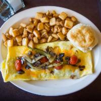 Veggie Omelet · Loaded with onions, bell peppers, mushrooms, tomatoes and cheddar cheese. Served with breakf...