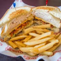 Turkey Club · Slow-roasted turkey breast, hickory-smoked bacon, American and Swiss cheeses on grilled sour...