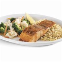 Wild-caught Pacific Salmon with Sweet Heat Glaze · Grilled salmon filet topped with a sweet and zesty glaze, then served with rice pilaf and st...