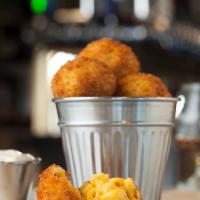 Bacon Mac and Cheese Balls · House made bacon mac and cheese balls breaded with panko and served with Tapatio ranch for d...