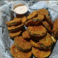 Fried Pickle Chips Nibbler · Gluten-free flash fried pickled chips served with signature crave sauce.